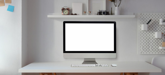 Blank screen desktop computer in modern office room with office supplies