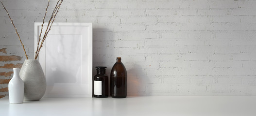 Minimal workspace with mock up frame and copy space, white desk and vintage brick wall