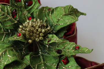 Close up Holly Leaves Decorated with Gold Glitter Sequins 