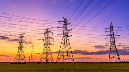 Fototapeta na wymiar High voltage electricity tower sky sunset landscape,industrial background.