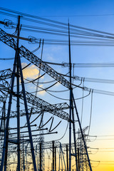 High voltage electricity tower at sunset.substation industrial background.