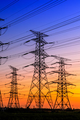 Fototapeta premium High voltage electricity tower sky sunset landscape,industrial background.
