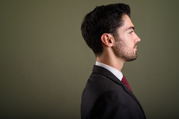 Closeup profile view of young handsome businessman in suit