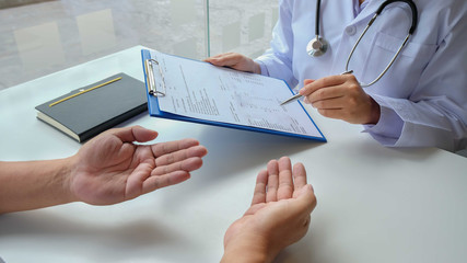 The female doctor sat on the examination of the patient's history and was ready to listen to the patient to clarify the symptoms. Concept of treatment and good health