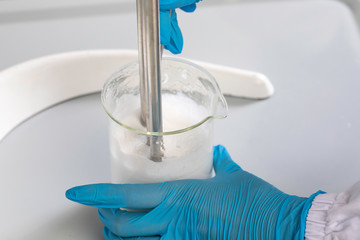 Medical experiment, fluid in mixer lab equipment close up