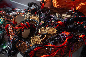 wooden decorations with a sun sign. On the laces of their fabric. Jewelry texture