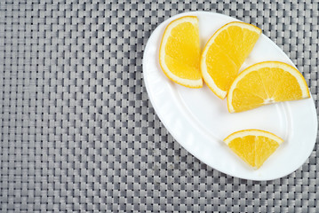 slices of orange on a white plate flatlay