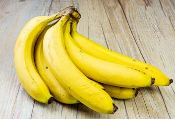 Bananas with blemishes up close on a wooden background 