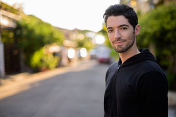 Fototapeta premium Young handsome man with stubble beard outdoors