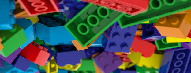 Colored toy bricks background. Rainbow colors. Random coloured plastic construction blocks. 3D illustration. 3D rendering