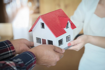 Real Estate Agents Giving Homes to Customers. Concepts of real estate and land.