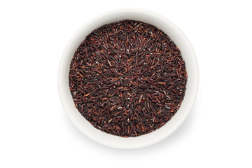 Uncooked brown rice for health in a ceramic bowl isolated on white background with clipping path.