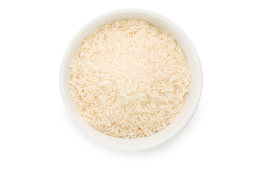 Uncooked rice in a ceramic bowl isolated on white background with clipping path.
