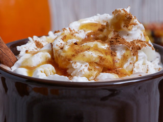 Close up of whipped cream with caramel syrup and sprinkles