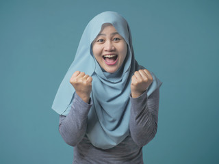 Muslim Lady Smiling with Winning Gesture