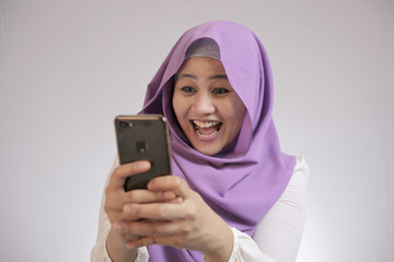 Young Muslim Woman Get Good News on Her Phone