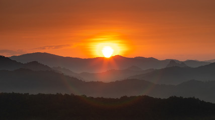 Morning mist covered on hill after sunrise at tropical forest. Thailand