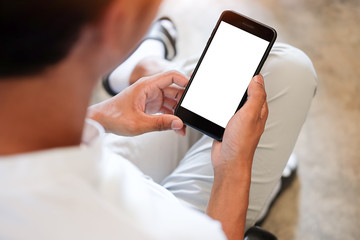 Mock up smartphone of hand holding black mobile phone with blank white screen.