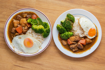Chicken curry Rice on wooden background ( Poached egg, Potato, enoki mushroom, onion, broccoli, Japanese style,)