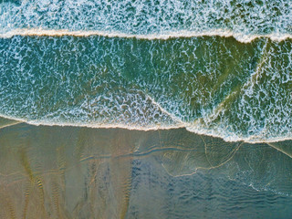 Aerial drone image of waves lapping on the shore of a South Carolina Beach