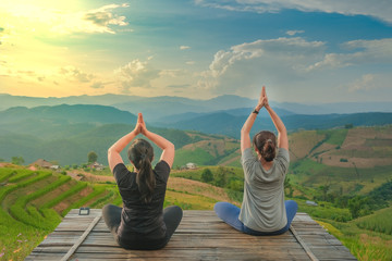 Healthy woman lifestyle balanced practicing meditate and zen energy yoga outdoors on the bridge in...