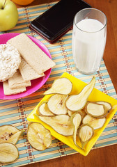 Breakfast with milk and fruit chips made of pears and crispbreads. Healthy vegetarian dietary food