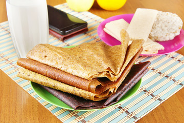 Breakfast with milk and various fruit pastilles and crispbreads. Healthy vegetarian dietary food