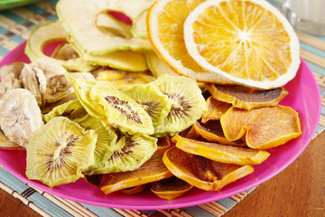 Heap of various fruit chips in a plate. Healthy vegetarian food