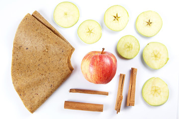 Ingredients for fruit pastille made of cinnamon and apples on white background. Healthy vegetarian dietary food