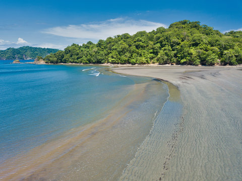 aerial drone image of Curo Beach in Costa Rica showing the diverse jungle trees and beach
