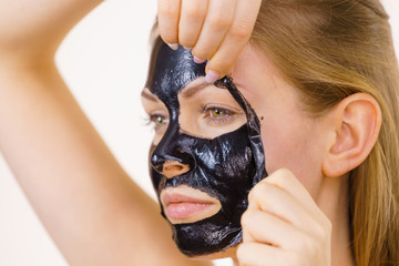 Girl removes black mask from face