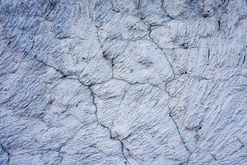 Plaster mortar texture with white cement. Surface texture with cracks. Old concrete wall.