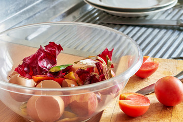 A bowl of food recycling waste on the kitchen. Closeup, selective focus