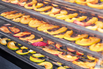 Sliced apples in the food dryer. Cut apples on dehydrator tray. Closeup, selective focus