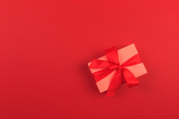 Gift box with ribbon and bow on color background and space for text. Top view - Image