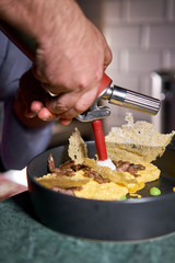 The chef serves the dish Pumpkin Risotto with with duck and parmesan cheese mousse. Seasonal autumnal recipe - risotto with organic pumpkins.