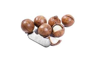 Open Macadamia nut by tool on background