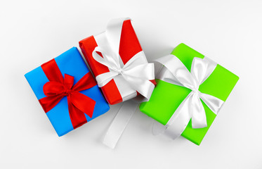 Three beautiful wrapped gifts isolated on white background