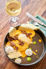 Dinner in restaurant. Pumpkin Risotto with with duck and parmesan cheese mousse. Seasonal autumnal recipe - risotto with organic pumpkins.