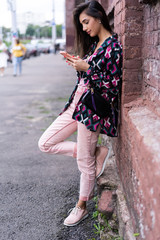 Natural young woman reading an sms or text message on a mobile phone