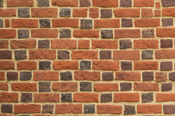 Old red brick fortress wall with gray cement mortar textute