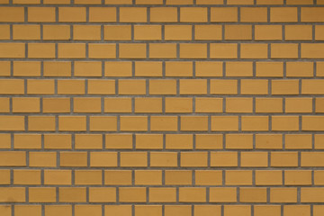 Old yellow brick fortress wall with gray cement mortar textute