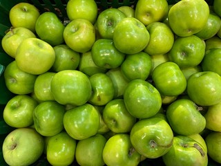 Fragrant ripe apples on a store counter. Vitamins