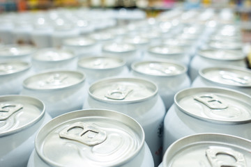 Many metal cans with cool drinks. A group of objects.