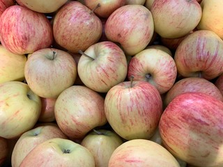Fragrant ripe apples on a store counter. Vitamins