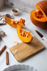 pumpkins with cinnamon sticks on marble backgrund