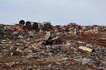 Fuel drums and piles of scrap metal waste in the Arctic
