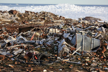 Fuel drums and piles of scrap metal waste in the Arctic