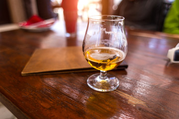 Half-empty glass with an alcoholic drink.