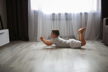 Boy child 6 years old lying on floor in hysteria
